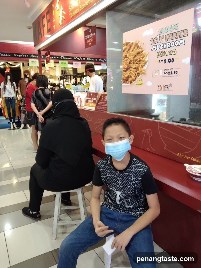 Food stall with promotional poster