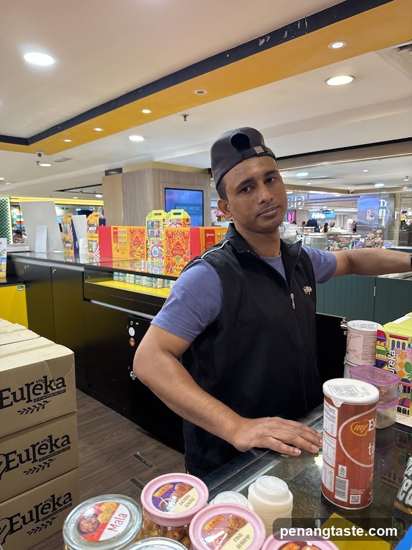 Man behind a counter with products