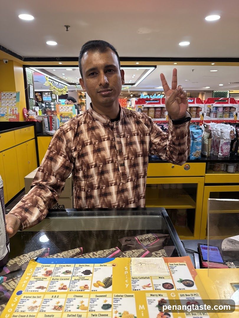 Man behind a counter with a menu