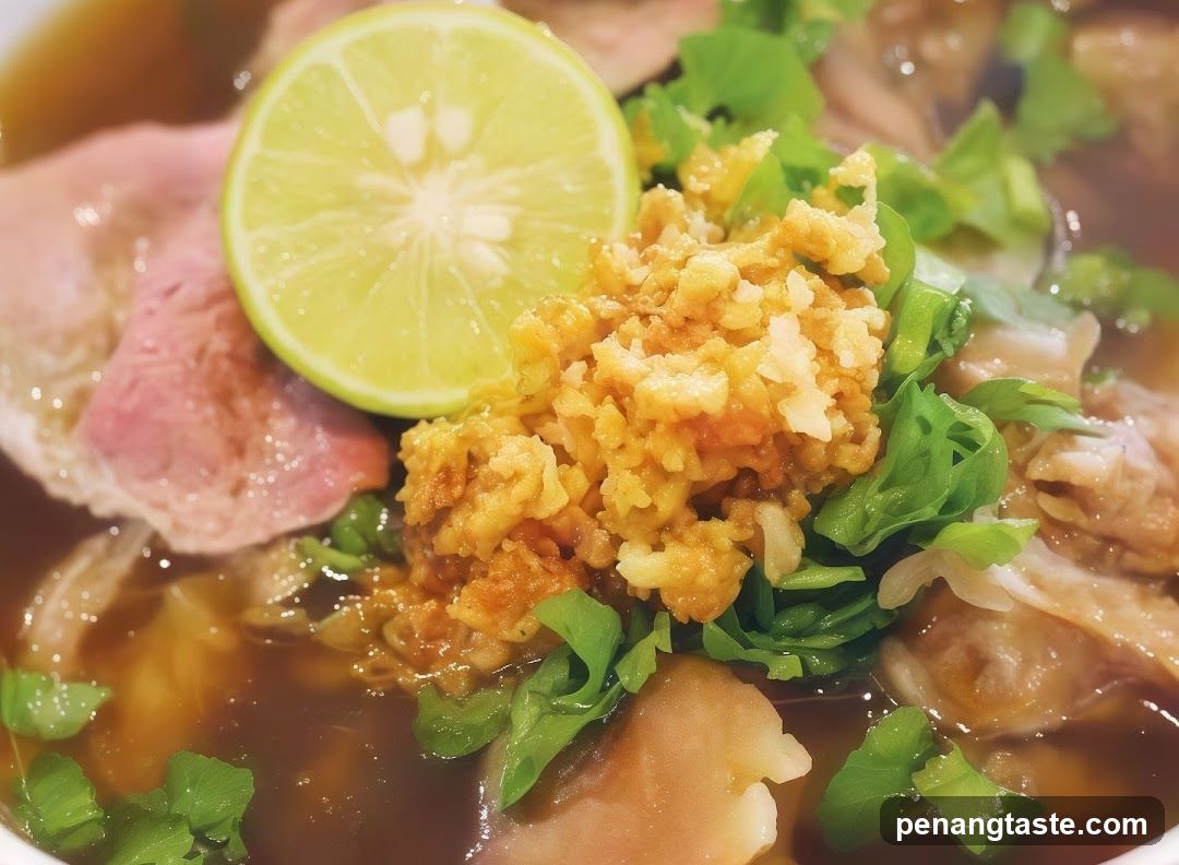 Close-up of a bowl of soup with meat and lime