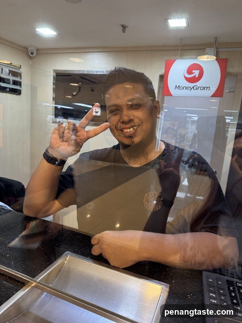 Man making peace sign at MoneyGram counter