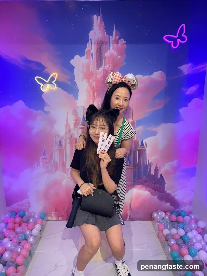 Two people posing in front of a castle backdrop