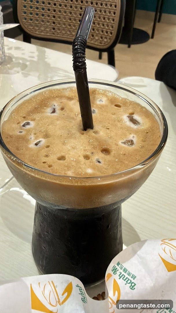 Iced Coffee with Foam and Ice Cubes