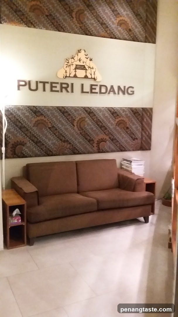 Waiting area with couch and signage