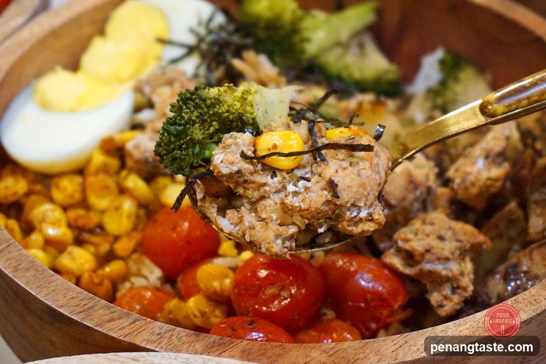 Close-up of a healthy grain bowl with chicken and vegetables.