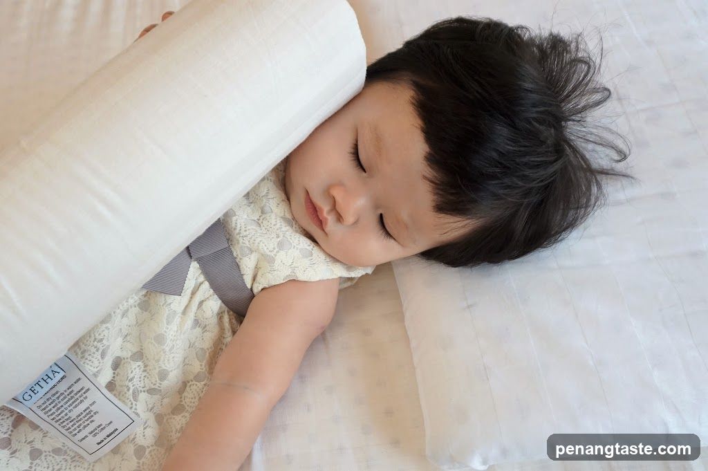 Baby sleeping with a bolster pillow