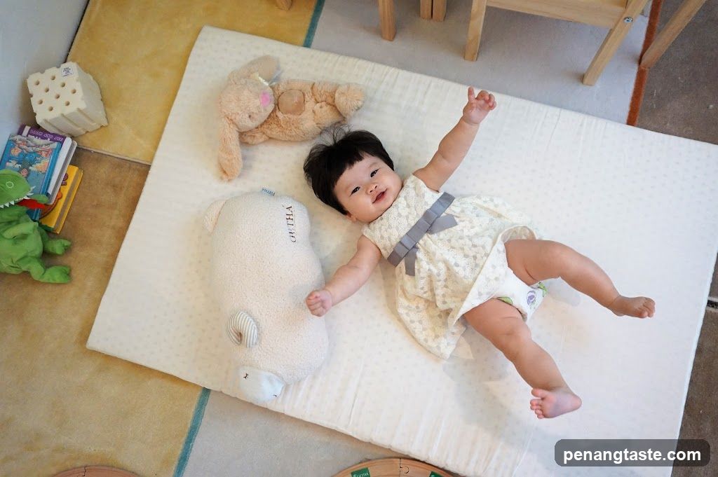 Baby on a playmat with toys