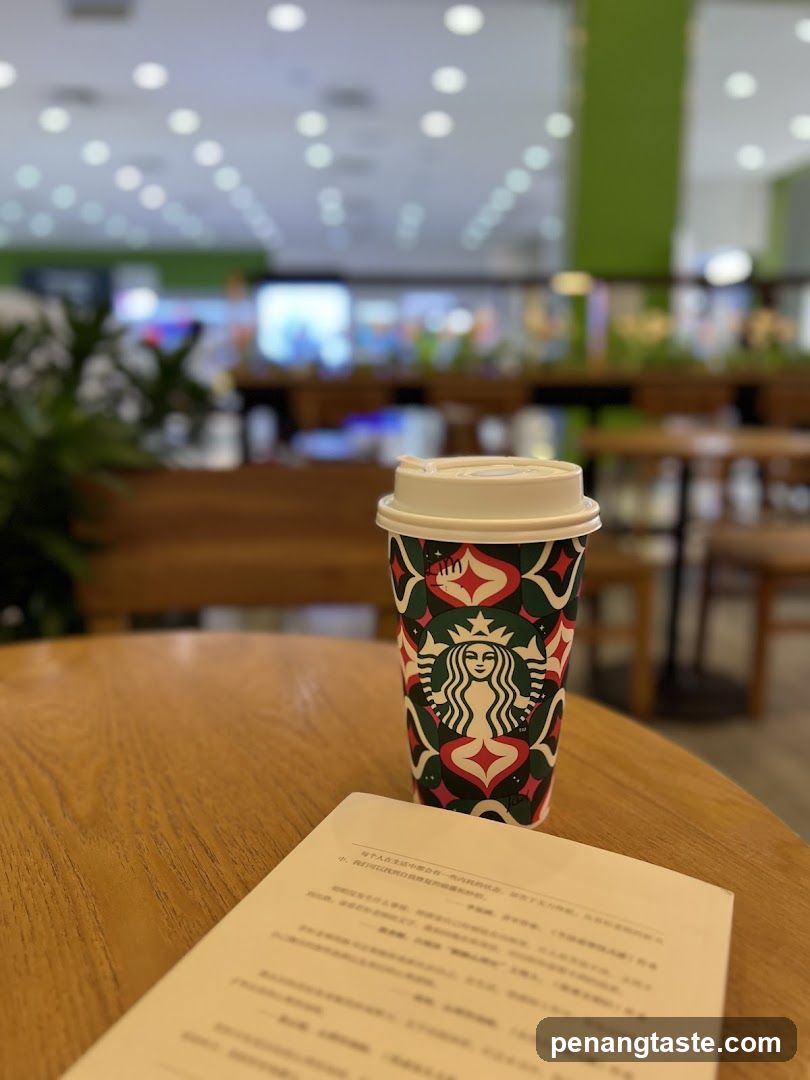 Starbucks cup and book on table