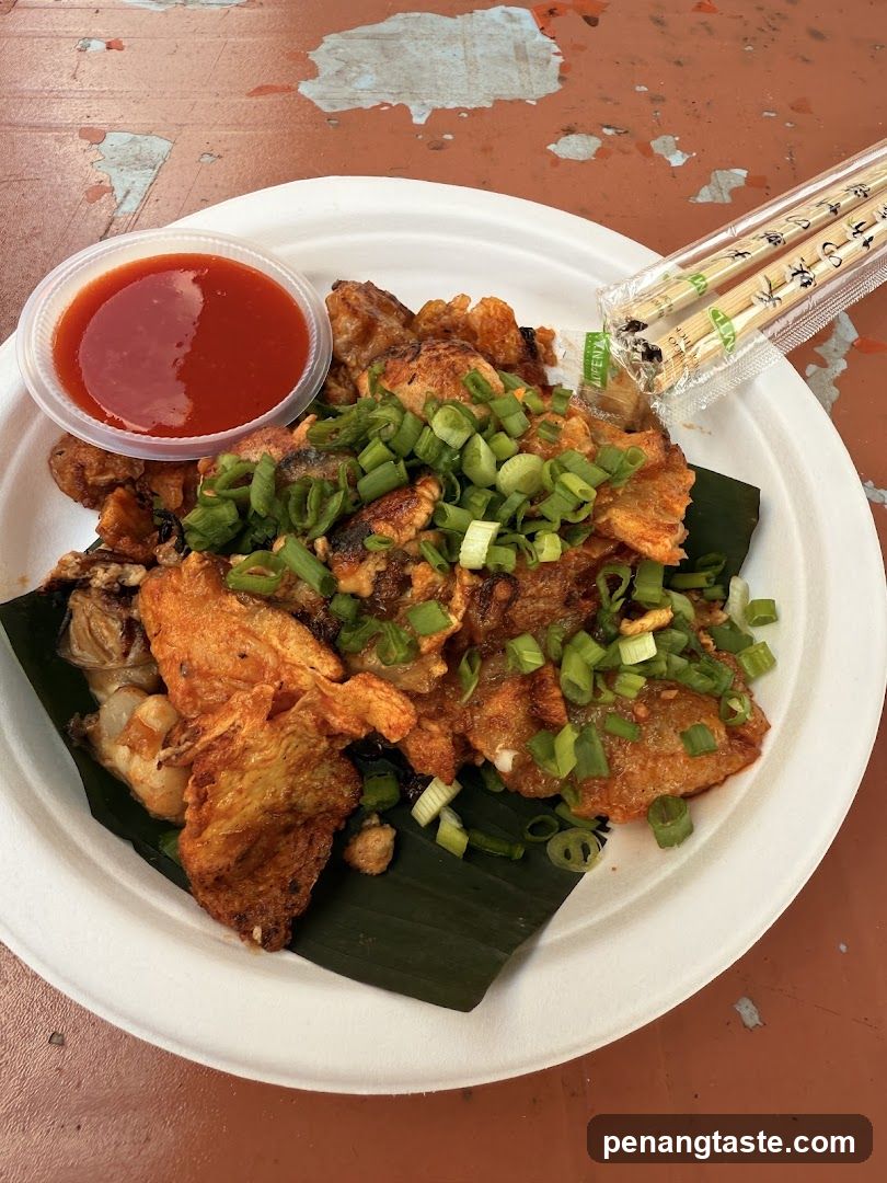 Oyster omelet with chili sauce and chopsticks