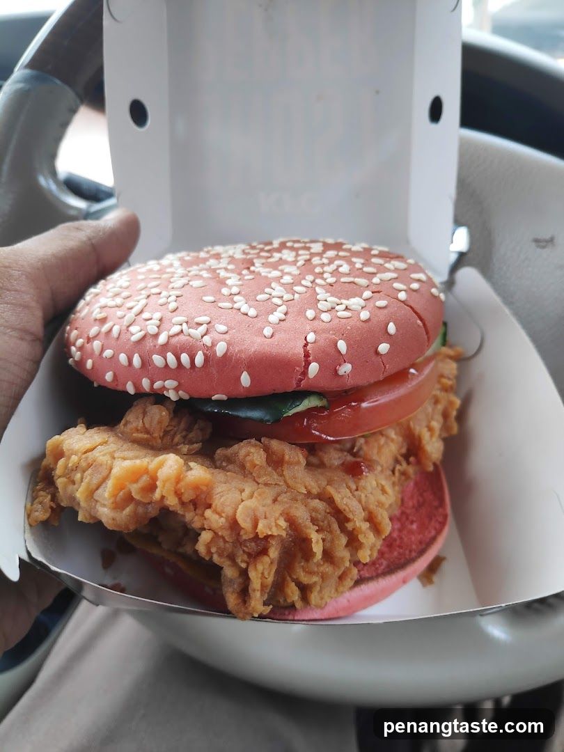 Hand holding burger in car