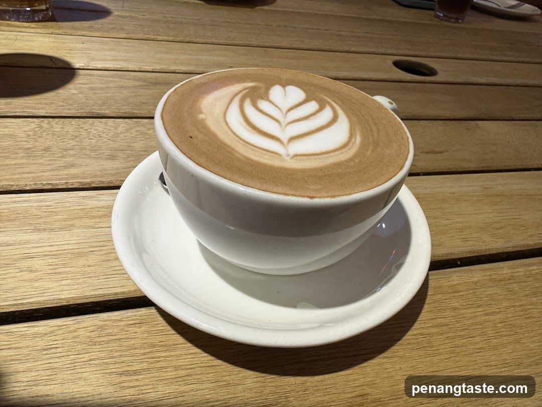 Coffee with latte art on wooden table
