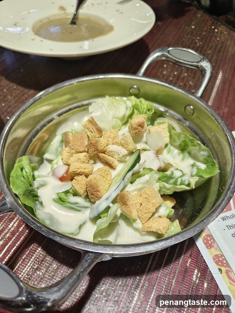 Salad in metal bowl on table