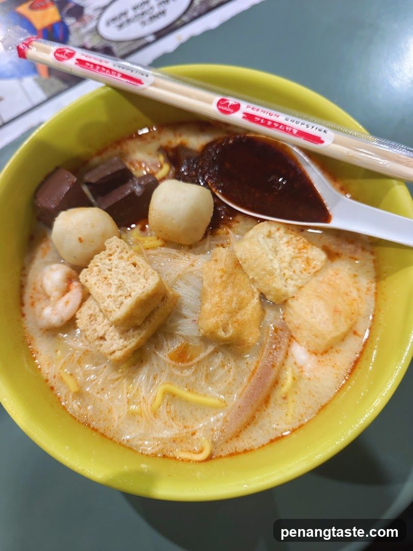 Lunch bowl with chopsticks and spoon