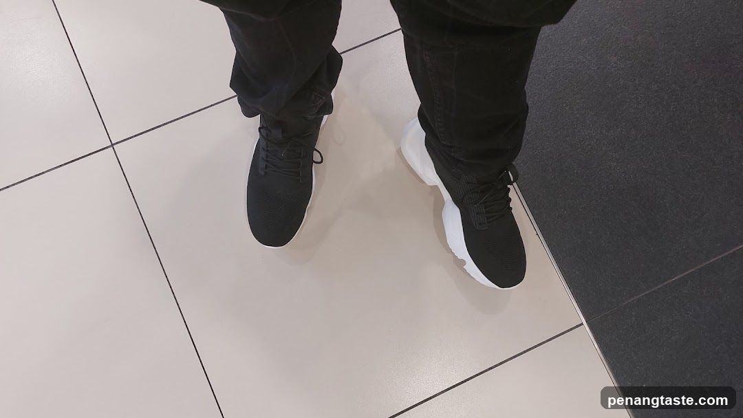 Person's Feet on Tile Floor