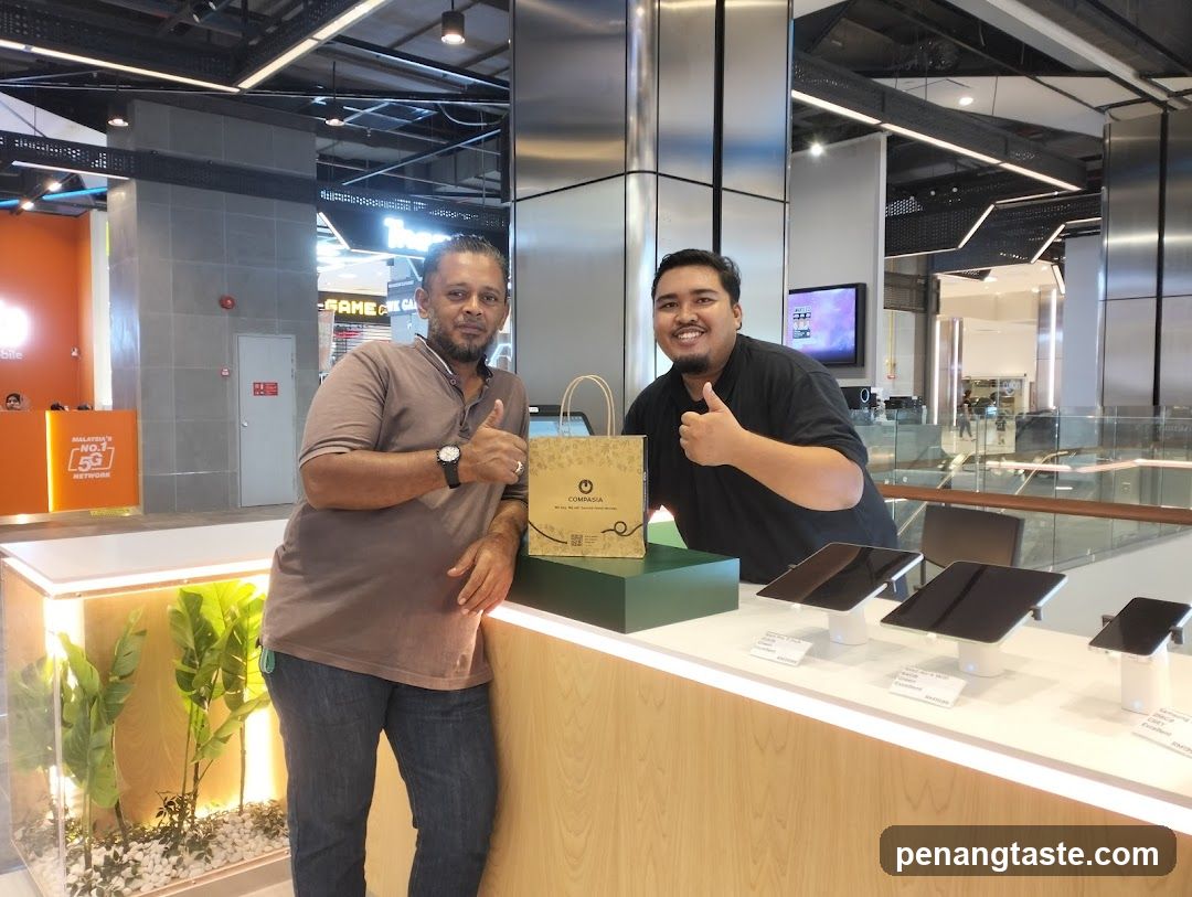 Two men posing in a retail store