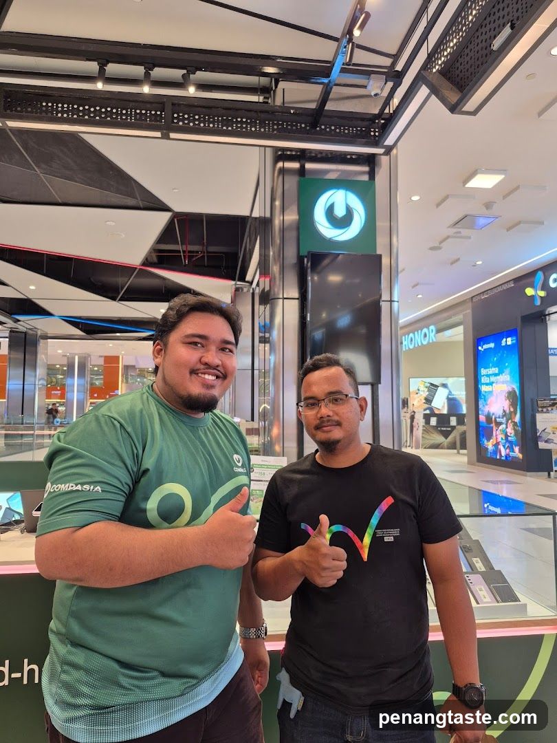 Two individuals posing inside a shopping mall