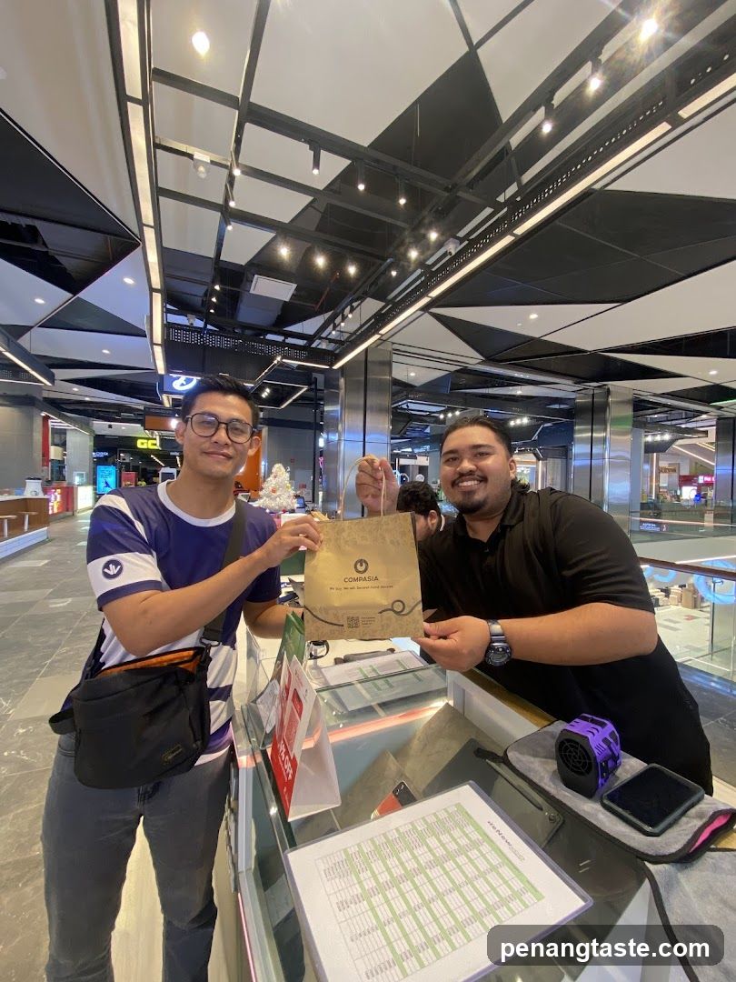 Two individuals at a counter in a shopping mall
