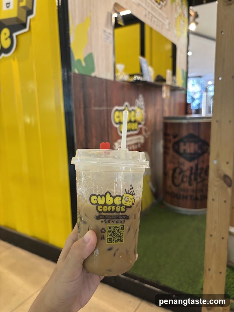 Hand holding a drink at Cube Coffee