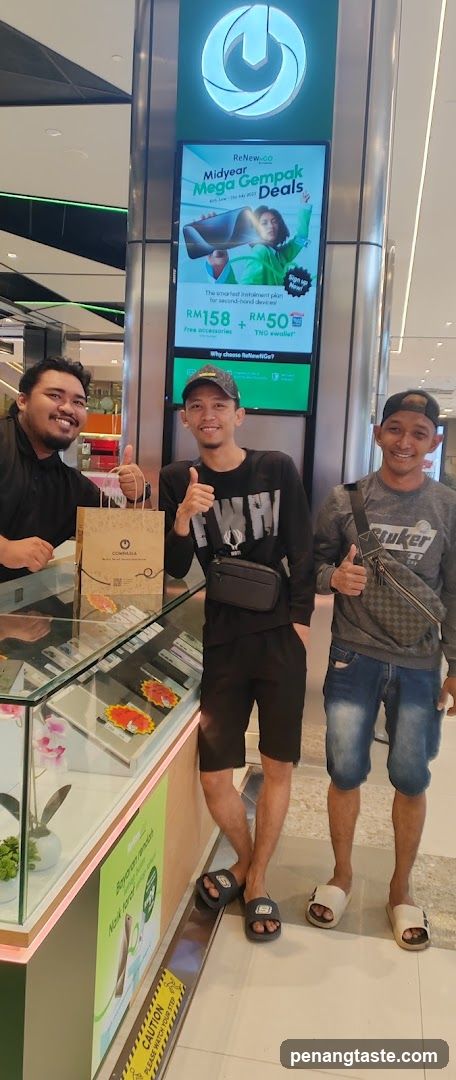 Three men posing in a shopping mall
