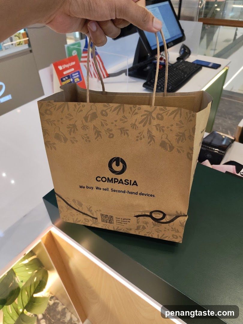 Hand holding COMPASIA shopping bag