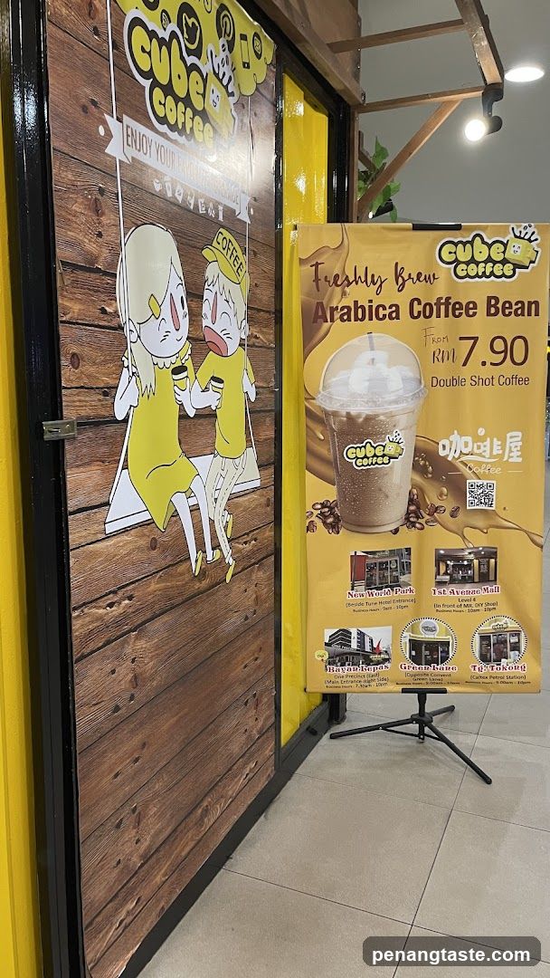Cube Coffee storefront entrance with promotional poster
