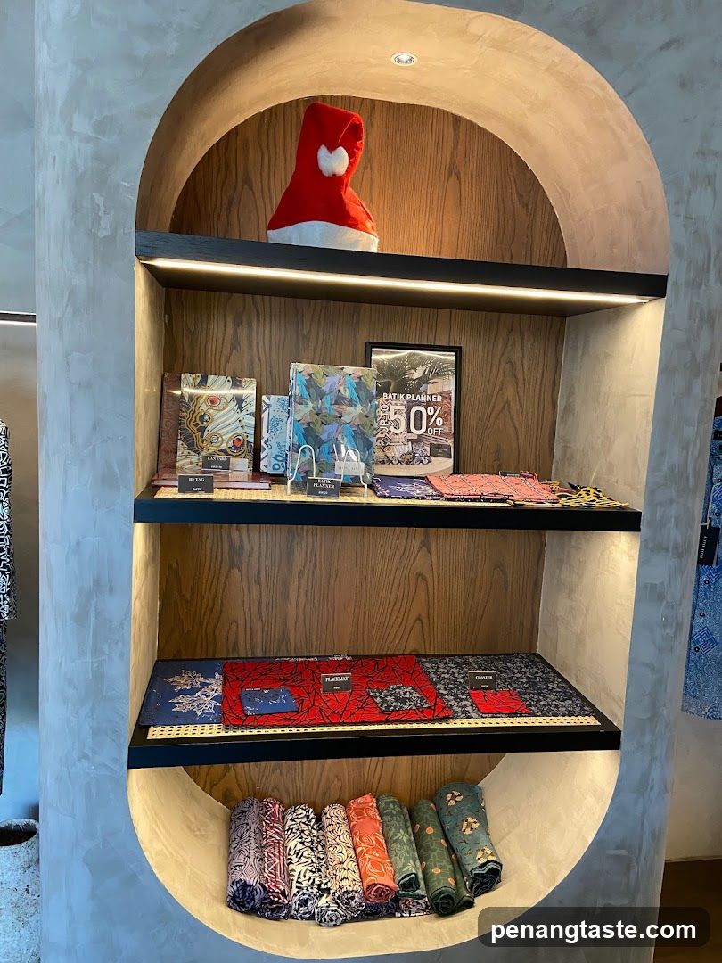 Display shelf with batik items and a Santa hat
