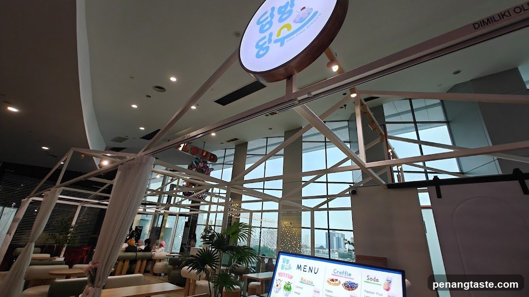 Interior of a modern café with large windows and exposed structural beams
