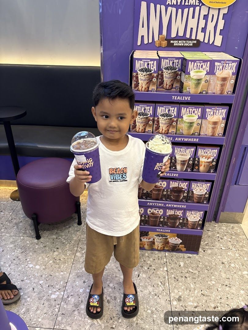 Child holding beverages in Tealive store