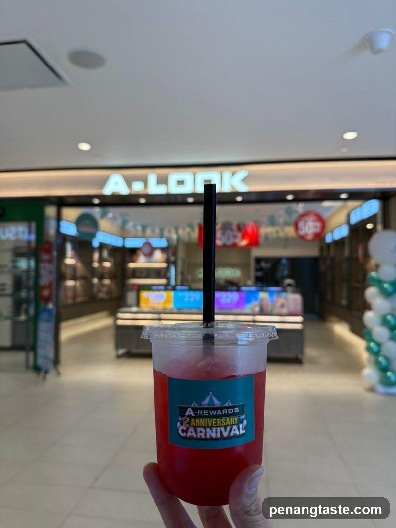 Hand holding drink in mall