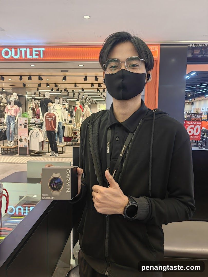 Person in retail store holding Garmin product box