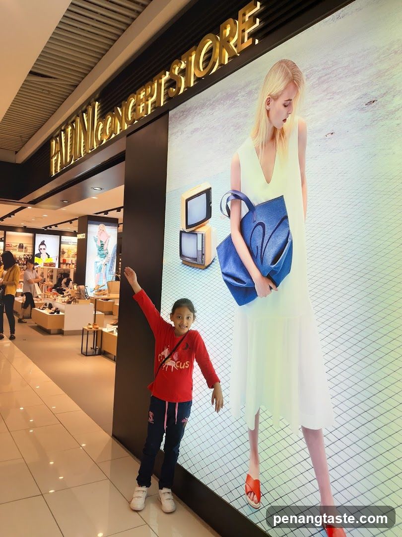 Child posing in front of store advertisement