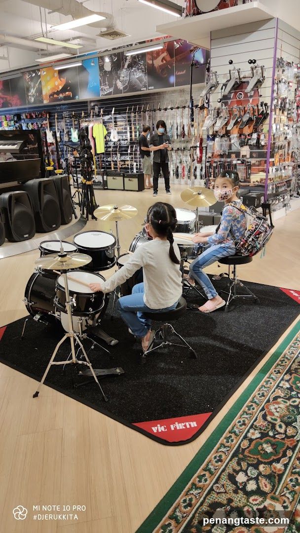 Children playing drums in a music store