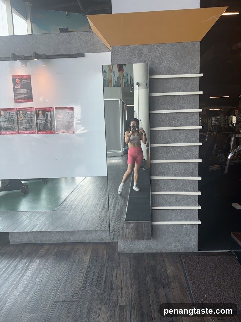 Gym Interior with Woman Taking Mirror Selfie