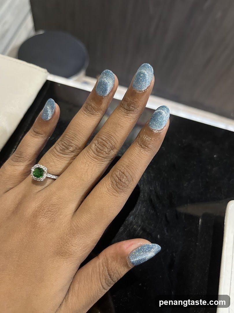 Hand with glitter nails and ring