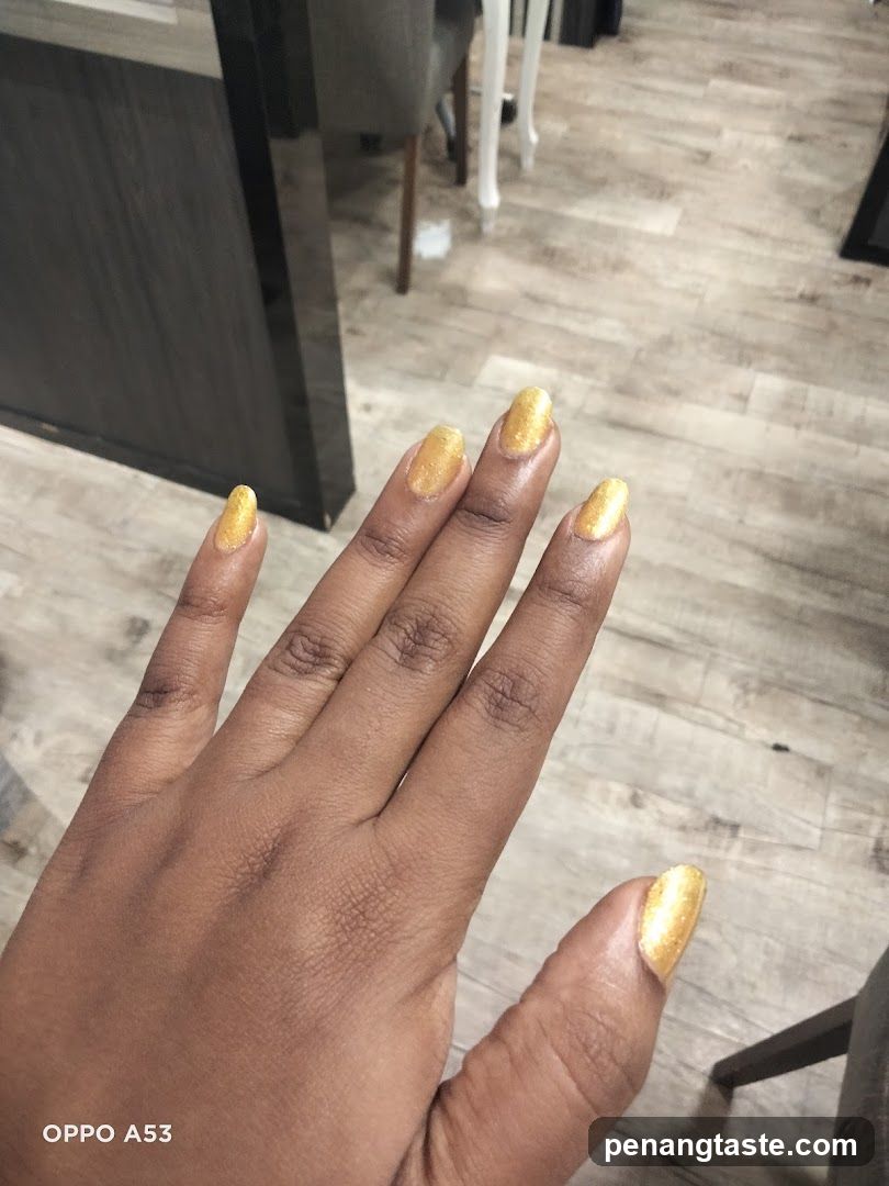 Hand with Gold Nail Polish