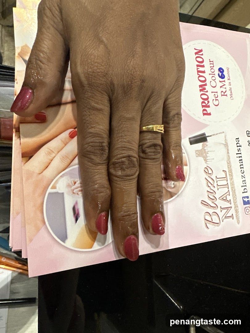 Hand with red nails resting on promotional flyer
