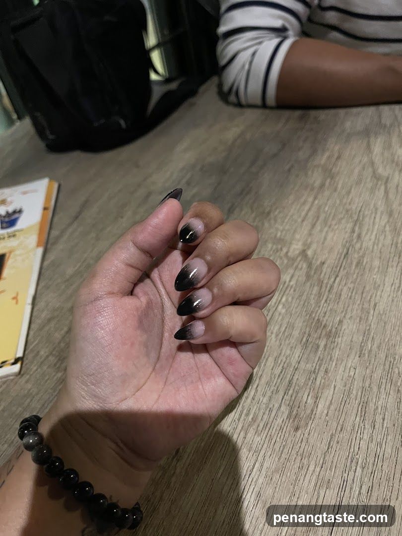 Hand with Nail Art on Wooden Table