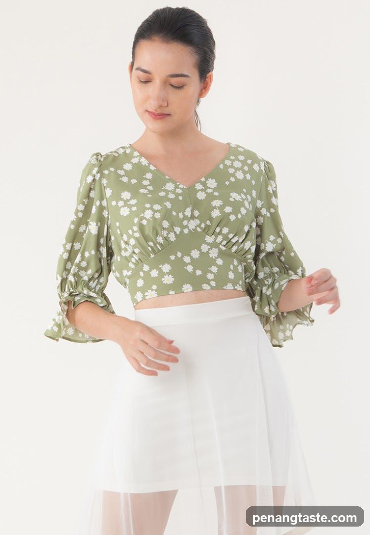 Model wearing floral top and white skirt