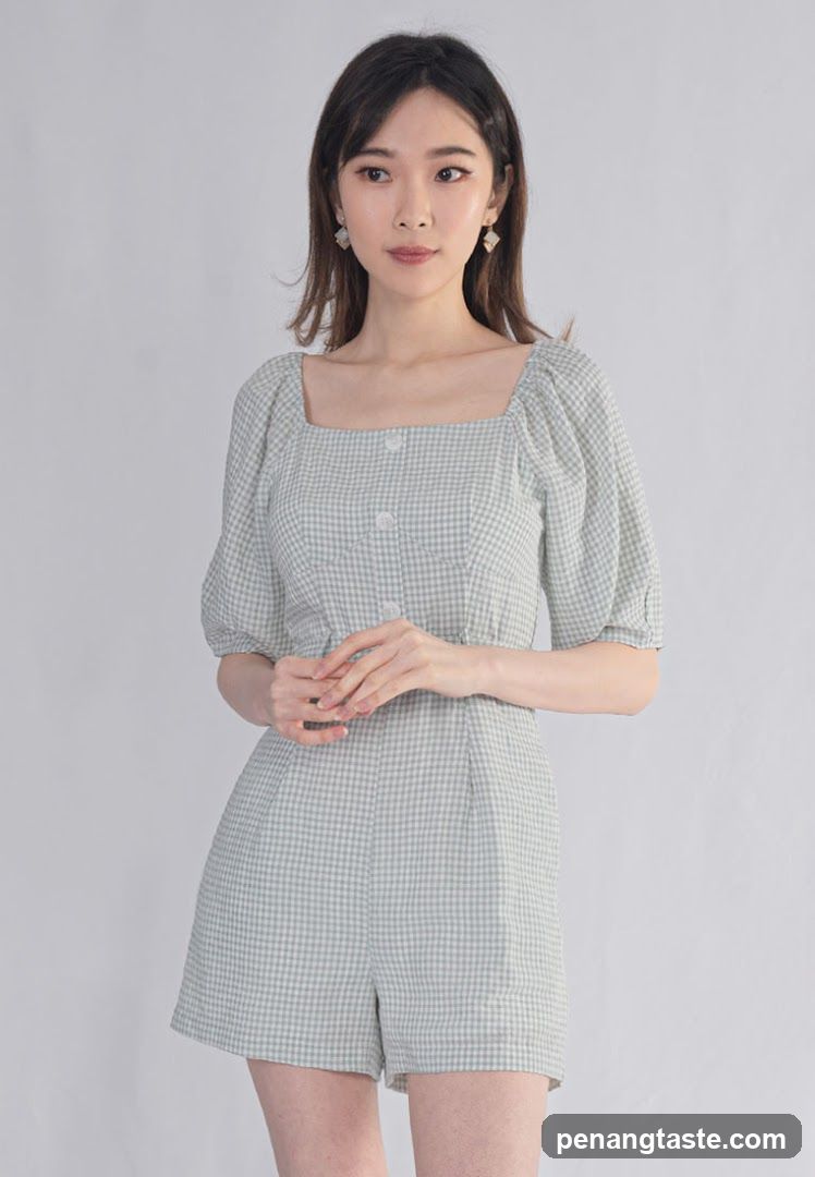 Model wearing checkered romper
