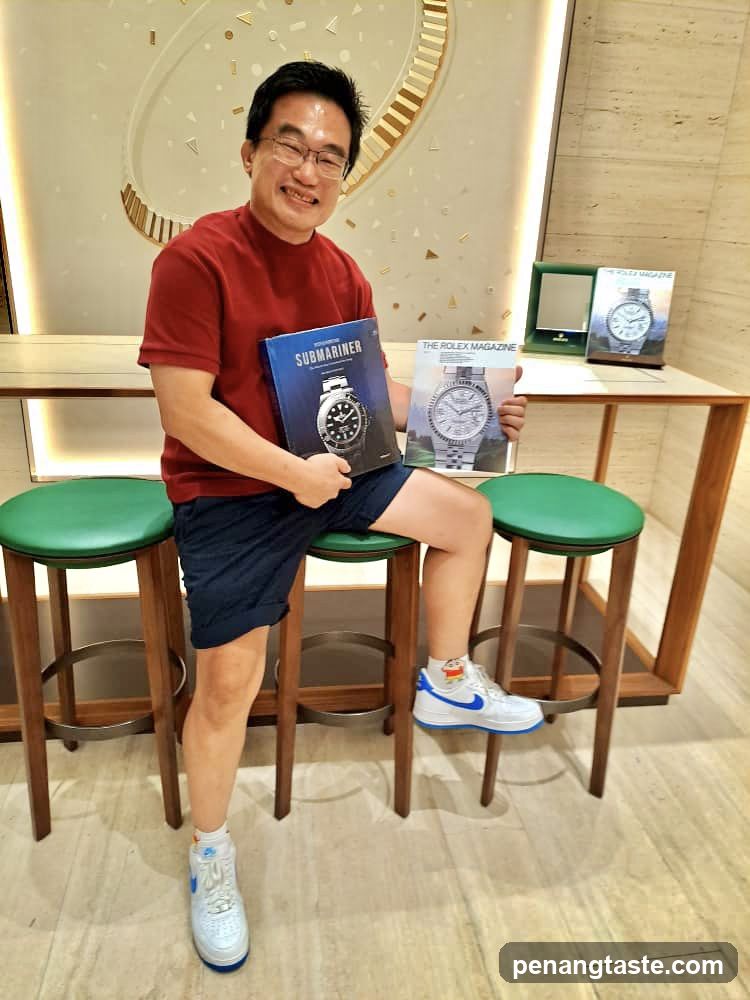 Man holding Rolex magazines