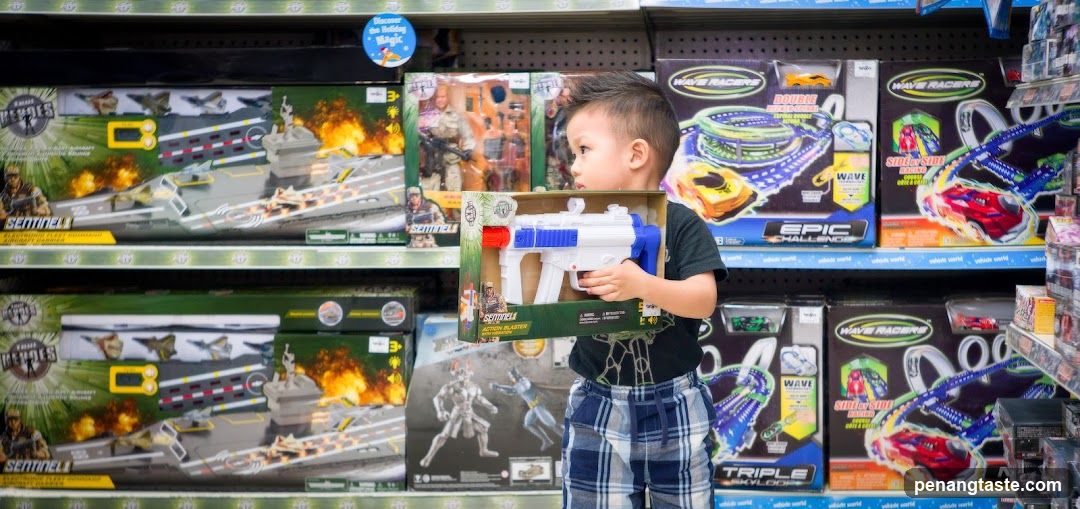 Boy Holding Toy Gun in Toy Store