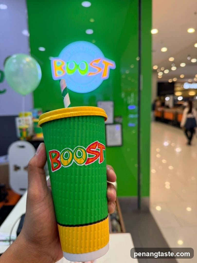 Boost Beverage Cup Held in Hand