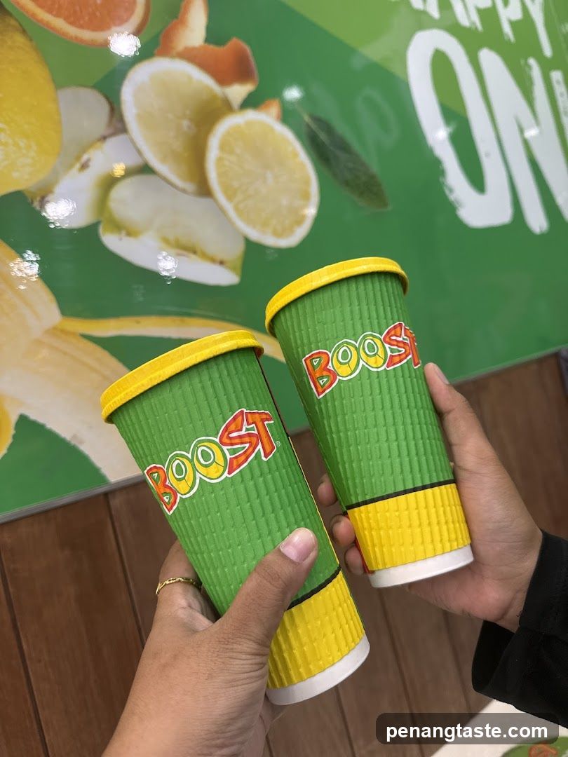 Boost Juice Cups Held in Hands