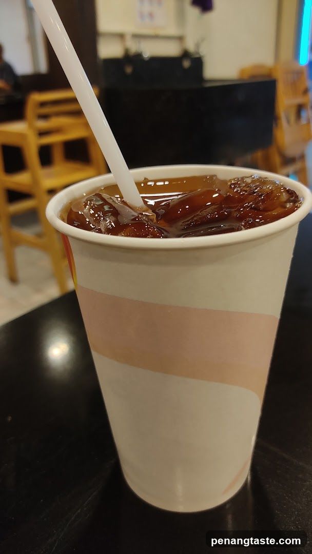 Iced beverage in paper cup with straw