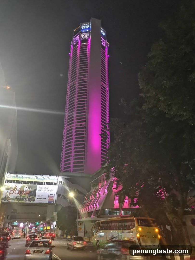 Nighttime cityscape with illuminated skyscraper