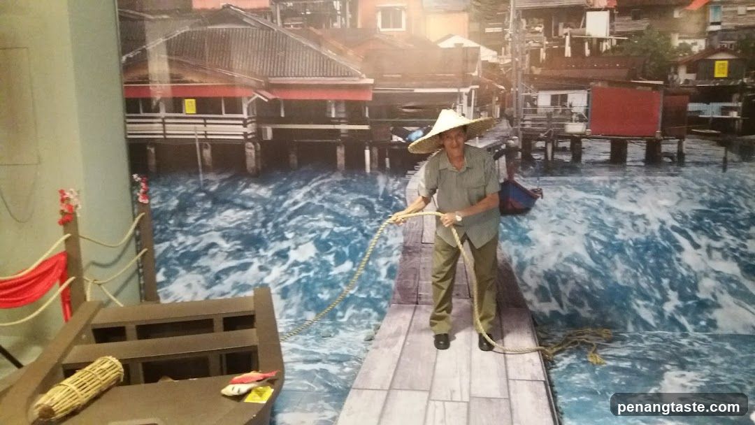Man in traditional hat on wooden dock display