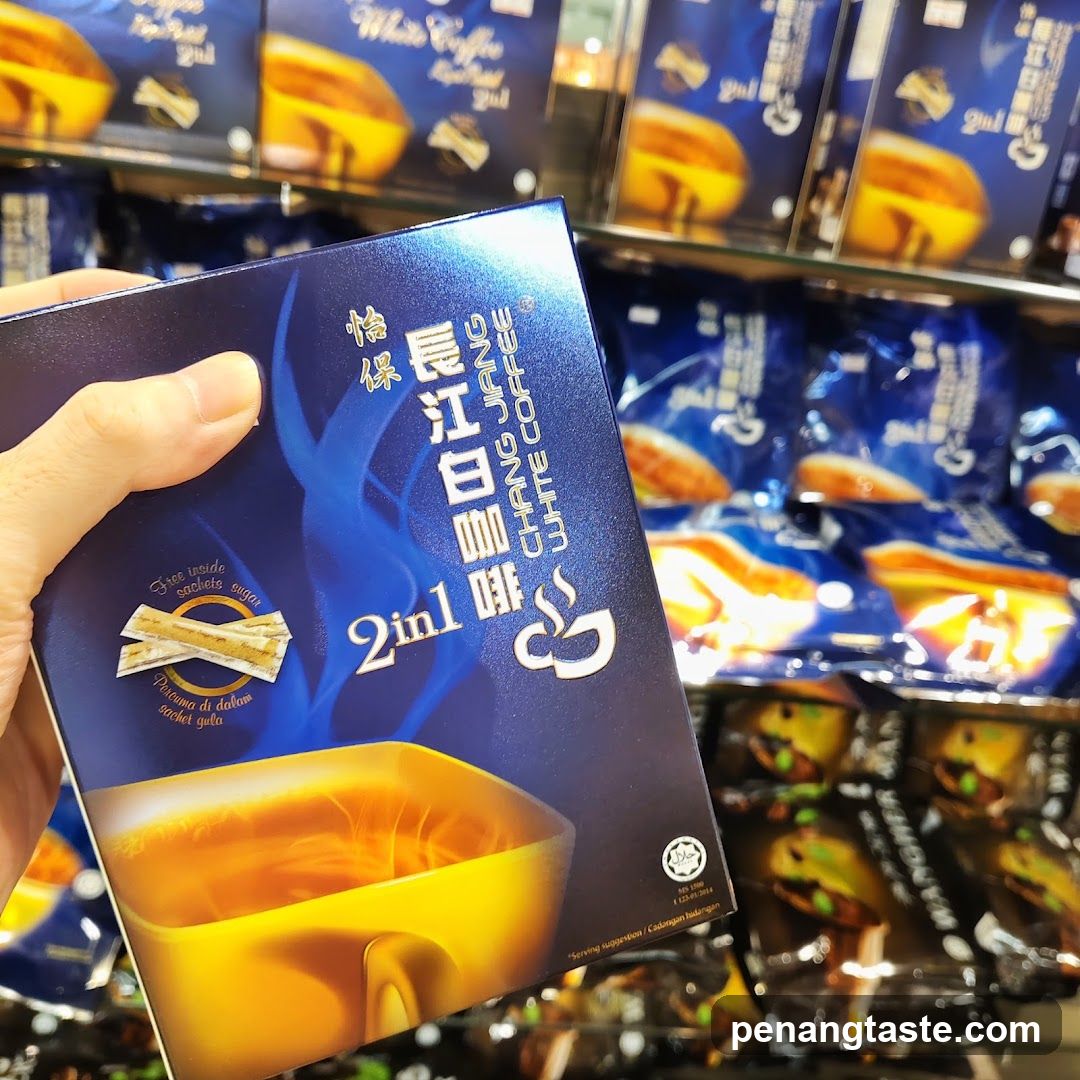 Hand holding Chang Jiang White Coffee product box