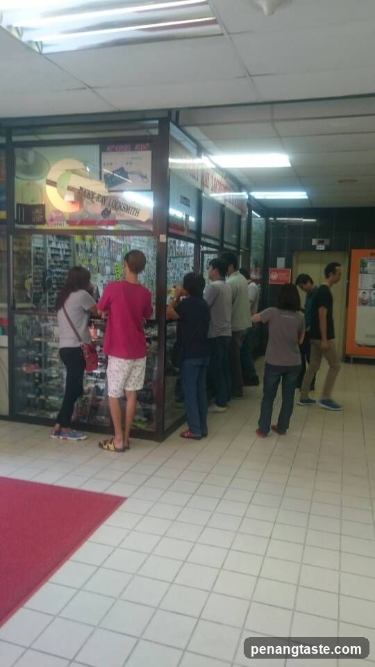 People in a mall corridor near a shop