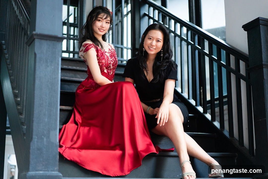 Two women posing on stairs