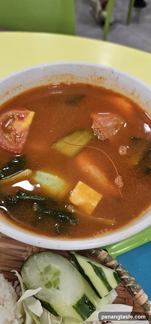 Bowl of Tom Yum Soup with Side Dishes